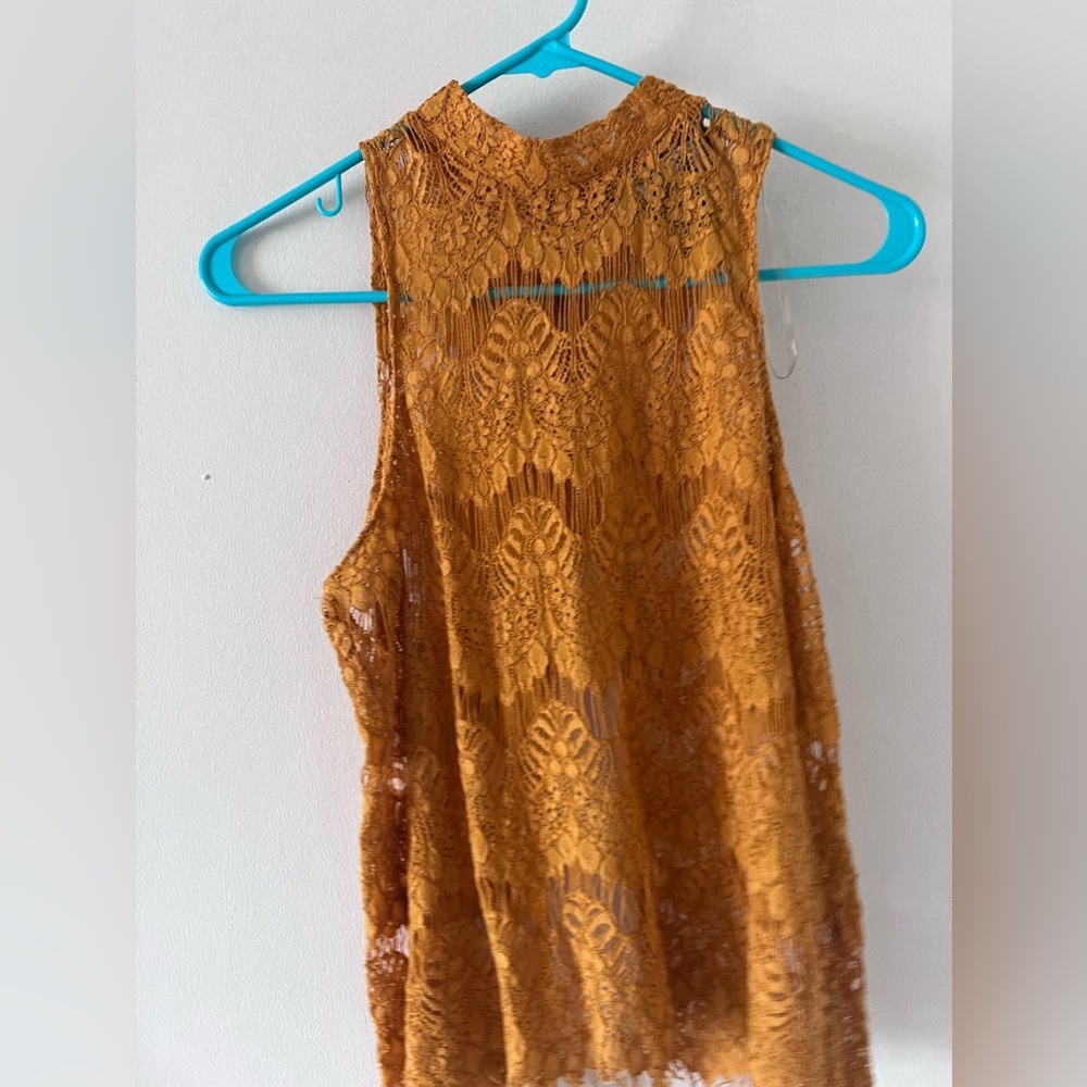 Mustard lace sleeveless shirt, slit in the lower back, size large